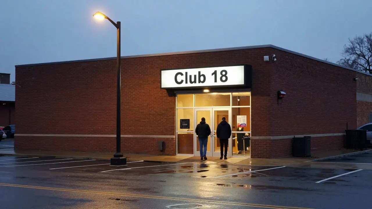 Exterior of a modest strip club building at dusk with simple signage and a well-maintained entrance.